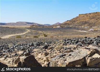 Desolate infinity of the Rocky hills of the Negev Desert in Israel. Breathtaking landscape and nature of the Middle East.