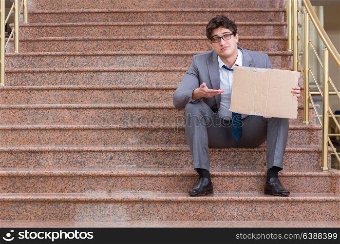 Desperate businessman begging on the street