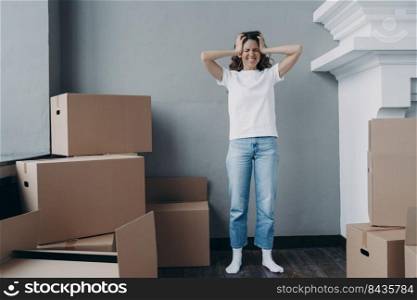 Desperate girl is moving. European woman packing boxes. Girl is upset with moving from modern apartment. Exhausted home owner is bankrupt and getting stressed from relocation.. Desperate girl is moving. Home owner is bankrupt and getting stressed from relocation.