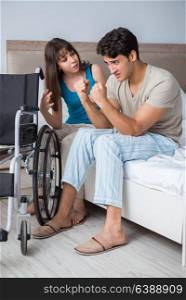 Desperate man on wheelchair with his sad wife