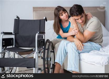 Desperate man on wheelchair with his sad wife