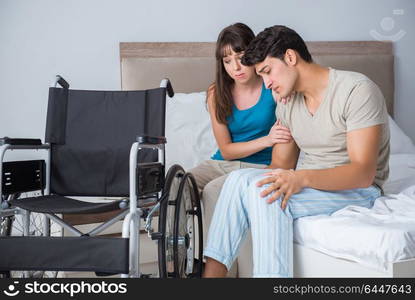 Desperate man on wheelchair with his sad wife