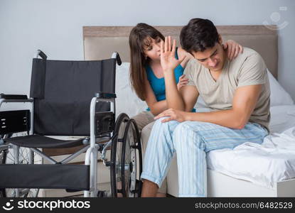 Desperate man on wheelchair with his sad wife