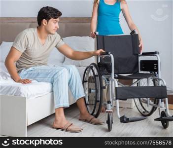 Desperate man on wheelchair with his sad wife. The desperate man on wheelchair with his sad wife