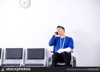 Desperate man waiting for his appointment in hospital with broke. Desperate man waiting for his appointment in hospital with broken arm. Desperate man waiting for his appointment in hospital with broke