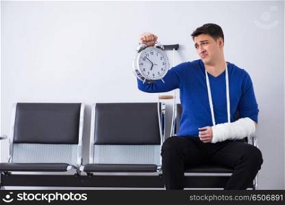 Desperate man waiting for his appointment in hospital with broke. Desperate man waiting for his appointment in hospital with broken arm. Desperate man waiting for his appointment in hospital with broke