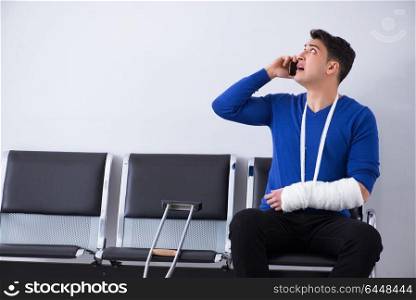 Desperate man waiting for his appointment in hospital with broken arm. Desperate man waiting for his appointment in hospital with broke