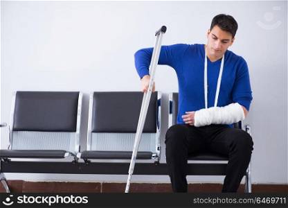 Desperate man waiting for his appointment in hospital with broken arm. Desperate man waiting for his appointment in hospital with broke