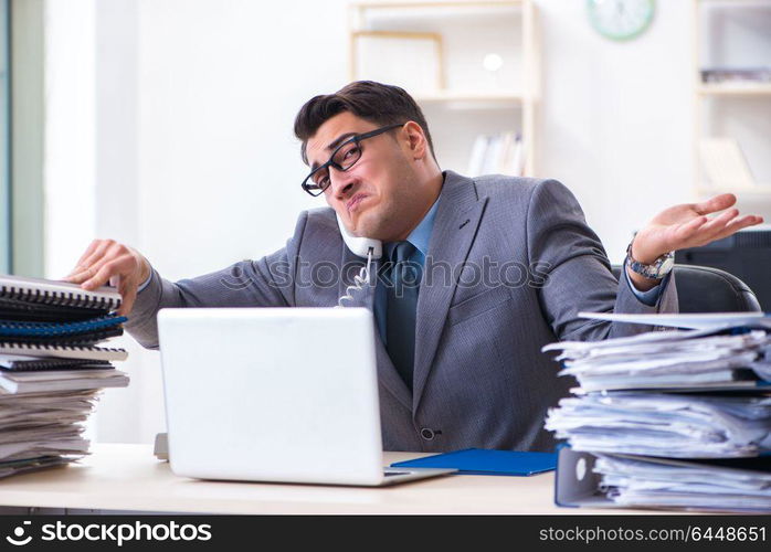 Desperate sad employee tired at his desk in call center