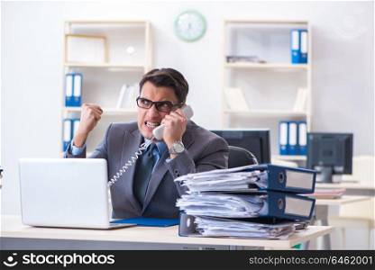 Desperate sad employee tired at his desk in call center