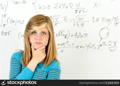 Desperate student girl standing in front of mathematics board