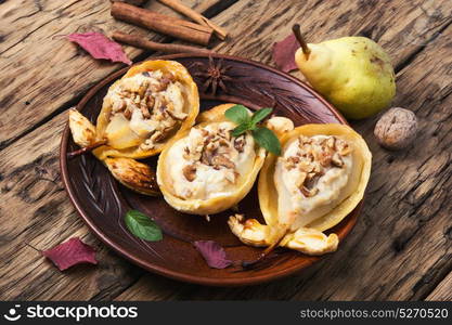 dessert baked pear. Autumn dish of pears stuffed with cheese, nuts and spices