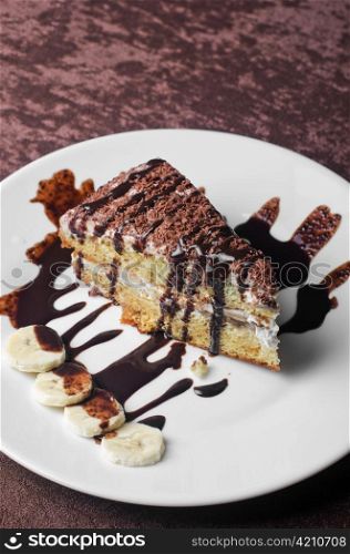 Dessert cake closeup with banana at plate