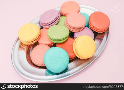 Dessert cake macaron or macaroon on pink background