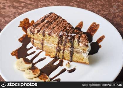 Dessert cake with banana ar plate
