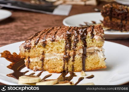 Dessert cakes with banana and coffee at table