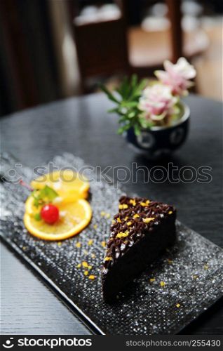 dessert food orange chocolate cake on wood background