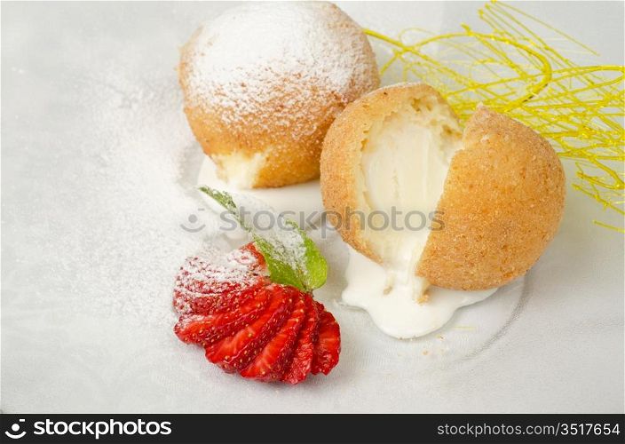 Dessert of ice-cream at biscuit with strawberry and caramel