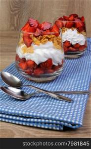 Dessert of strawberries with whipped cream and corn flakes