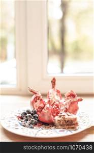Dessert plate with fruits and sweets in front of window. Natural light. Still life composition