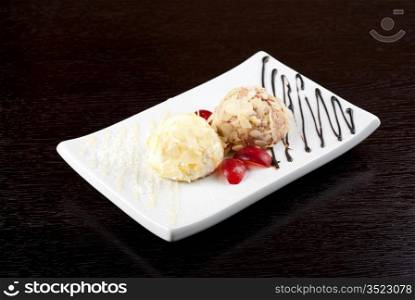 Dessert set of ice-cream with almond, chocolate and grapes
