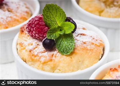 Dessert with berries and mint decor in white raclettes. Dessert with berries