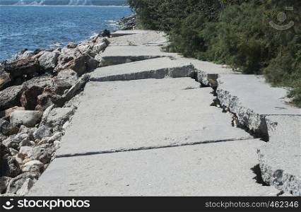 Destroyed by sea water erosion process seaside promenade concrete cover surface