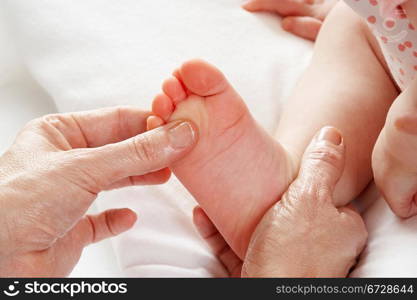 Detail baby having foot massage