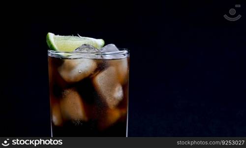 Detail from Cuba Libre drink on black background with copy or text space