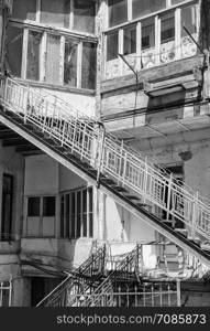 Detail image of an run-down apartment building with stairs