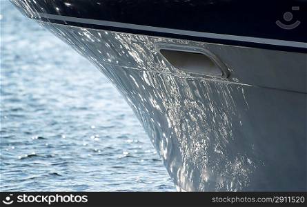 Detail image of sea reflecting on hull of yacht sailboat