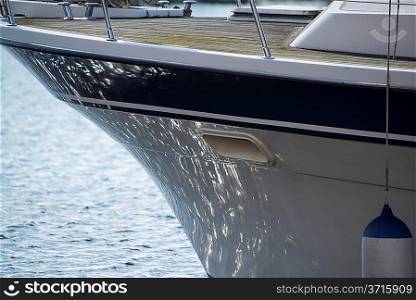 Detail image of sea reflecting on hull of yacht sailboat