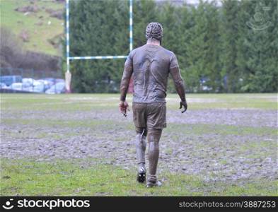 Detail muddy boots in a rugby match.