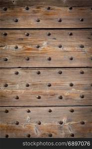 Detail of a 200 years old Italian door, made of wood. Background use.