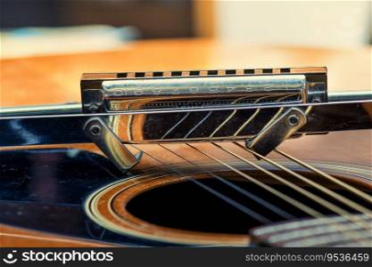 Detail of A blues harmonica and acoustic guitar