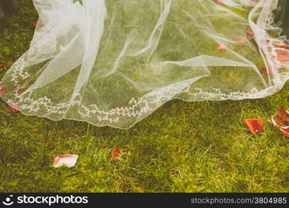Detail of a Bride&rsquo;s Dress over a Grass Floor