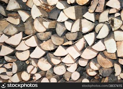 Detail of a bright firewood heap in an old woodshed