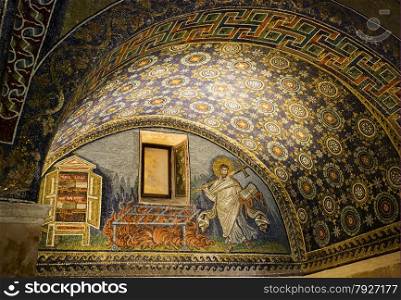 Detail of a Byzantine mosaic depicting St. Lawrence carrying the book of Psalms and a cross in the Mausoleum of Galla Placidia, in Ravenna, Italy.