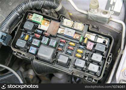 Detail of a car engine bay with fuses