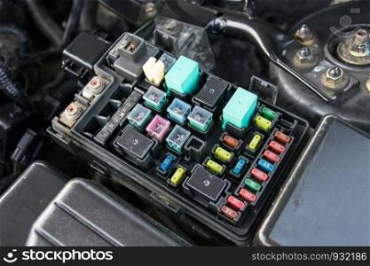 Detail of a car engine bay with fuses