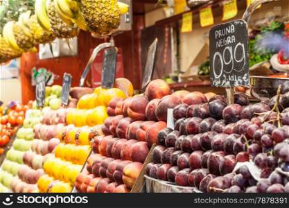 Detail of a colorful fruit market interior, prices in euro