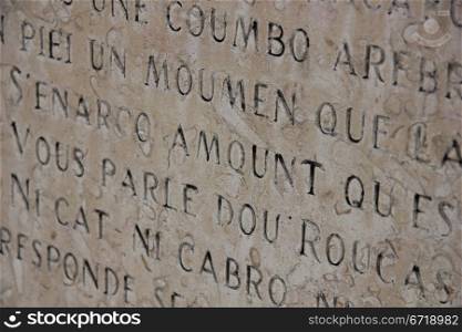 Detail of a inscripted stone in Provencal dialect
