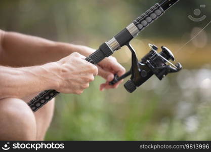 detail of a man hand on the fishing pole