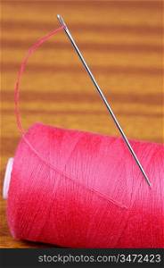 Detail of a needle with thread in a coil