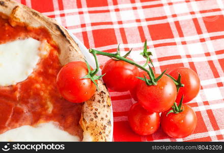 Detail of a Real Italian Pizza in Naples with Ciliegino tomatos