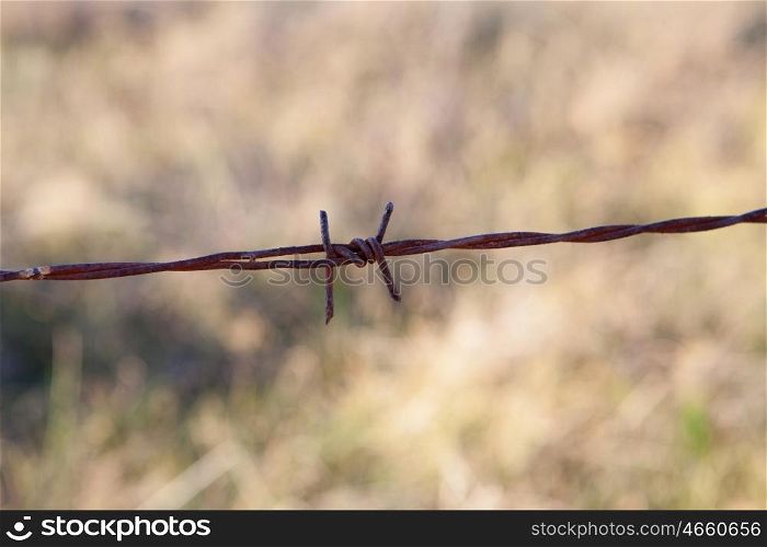 Detail of a rusty metal fence in the field