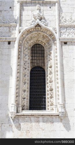 Detail of a smaller window of the south facade of the 16th century Gothic Jeronimos Monastery of the Order of Saint Jerome near the Tagus river in Lisbon, Portugal