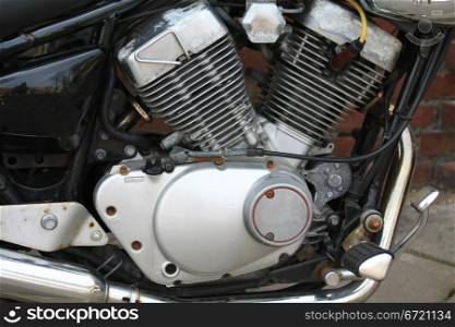 Detail of a vintage motorcycle engine, in black and metal