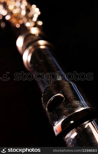 Detail of a Western concert flute, black background