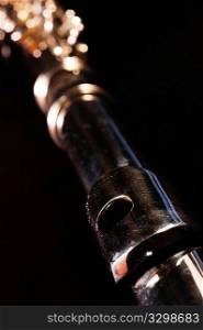 Detail of a Western concert flute, black background